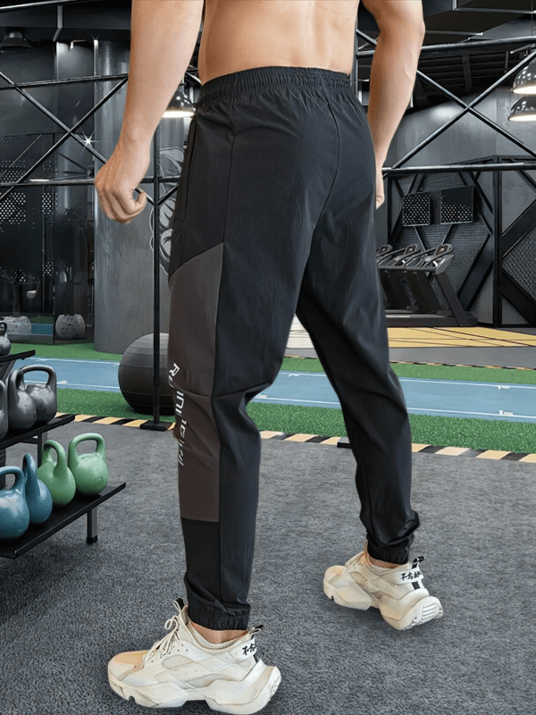 Stylish quick-drying men's sporty pants with cuffs for running, featuring flexible spandex blend and elastic waistband for comfort.